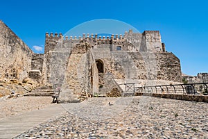 Cobblestone courtyard and wall facade of GuzmÃÂ¡n el Bueno castle, Tarifa SPAIN photo