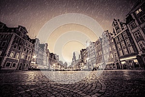 Cobblestone historic old town in rain at night. Wroclaw, Poland. Vintage