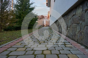 cobblestone path, next to the house is a cobblestone path