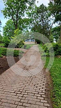 Cobblestone path to men& x27;s and women& x27;s public restrooms Riverside park guelph Ontario photo