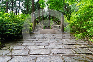 Cobblestone Path to Wood Bridge in manicured Japanese garden