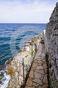 Cobblestone pathway coast beach mediterranean sea in south Antibes Juan-les-Pins France