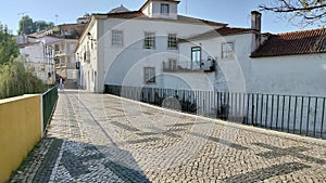 Cobblestone roadway of the bridge across Almonda River, at Alexandre Herculano Street, Torres Novas, Portugal