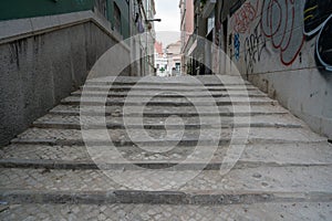 Cobblestone steps leading into an empty alleyway in daytime