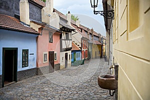 Cobblestone street and colorful 16th century cottages of artisans known as Golden Lane inside the castle walls Prague Czech Re