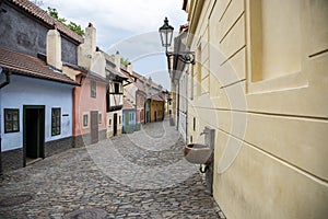 Cobblestone street and colorful 16th century cottages of artisans known as Golden Lane inside the castle walls Prague Czech Re