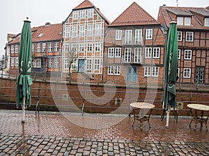 Cobblestone street with European houses in Stade, Germany.
