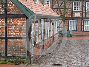 Cobblestone street with European houses in Stade, Germany.