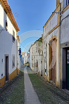 Cobblestone street lined with traditional townhouses in the old town