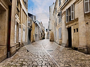 Cobblestone street with medieval houses in old city of Orleans photo