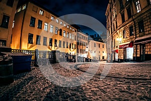 Cobblestone Street at Night With Buildings in the Background