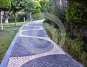 Cobblestone walk in the garden in summer.