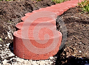 Cobblestones arranged in curve. Landscaping.