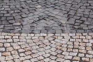 Cobblestones, pavement. Stone pavement texture. Granite patterned cobblestoned pavement floor background.