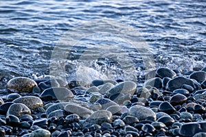 Smooth stones and water on the coast photo