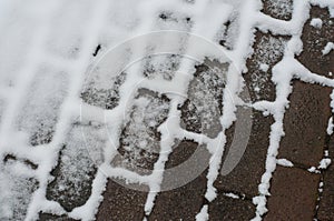 coblestone covered by snow in the street