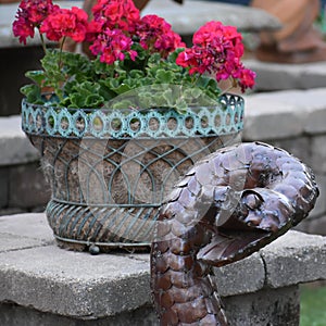 Cobra Snake Garden Statue with Red Begonias