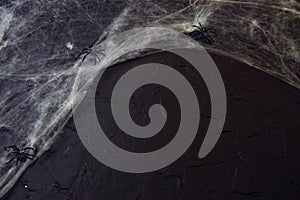 Cobweb or spider`s web against a black background, to be used as overlay for Halloween designs