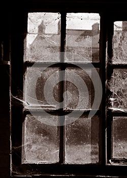 COBWEBS COVERING WINDOWS IN DERELICT TEXTILE MILL