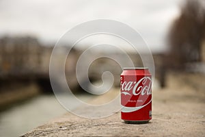 Coca cola can with Paris in blurry background