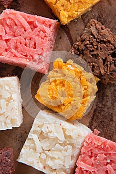 Cocada coconut candy, sweet Brazilian in background with rustic wood