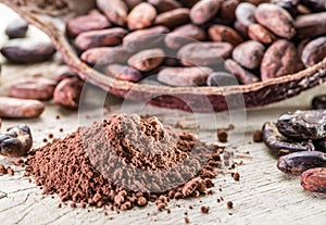 Cocao powder and cocao beans on the wood. photo