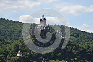 Cochem, Germany - 07 13 2020: Reichsburg Cochem on the hill with green forest in summer