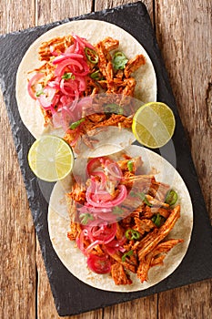 Cochinita pibil also puerco pibil or cochinita con achiote is a traditional Mexican slow-roasted pork dish from the Yucatan photo