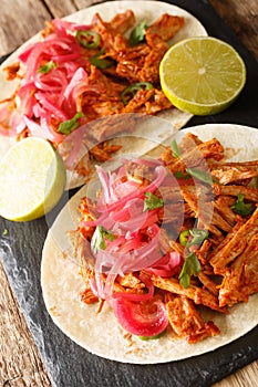 Cochinita pibil also puerco pibil or cochinita con achiote is a traditional Mexican slow-roasted pork dish from the Yucatan photo