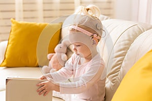 Cochlear implant for baby. Deaf child with hearing aid at home - diversity concept