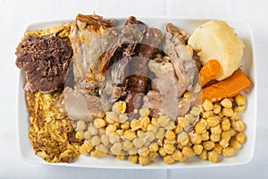 Cocido a Spanish stew with assortment of meat and chikpeas photo
