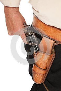 A cocked pistol pulled out of a leather holster