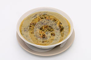 Cockles and Betel Leave Curry in a bowl on a white isolated background. Thai food. Top view.