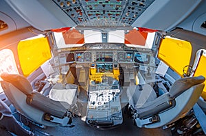Cockpit in the airplane, wide view of the control panel and pilot seats