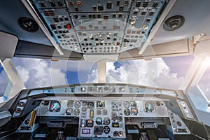 Cockpit with control panel against cloudy sky