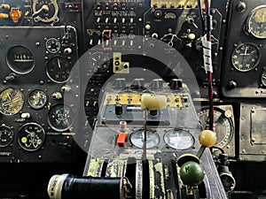 The cockpit control panel of the old plane close up. Detail of an old airplane cockpit with various indicators, buttons