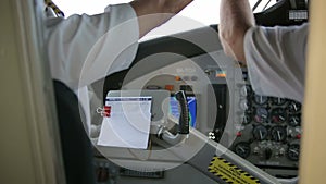Cockpit inside. Hands pilots run gadgets of seaplane.