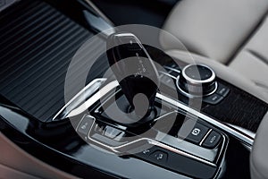 Cockpit interior cabin details. Automatic gear shifter in a modern expensive car. Car interior with close-up of