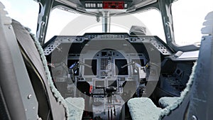 Cockpit interior of modern passenger aircraft with seats for two pilots. Control panel buttons and transparent