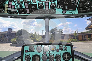 The cockpit of a Russian helicopter with control devices the names of the devices are written in Russian