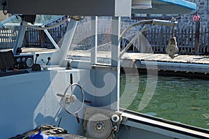 Cockpit of simple fishing vessel docked at pier