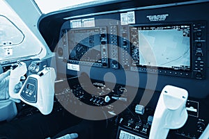 Cockpit of small, sport aircraft. A view of a glass cockpit dashboard and knap