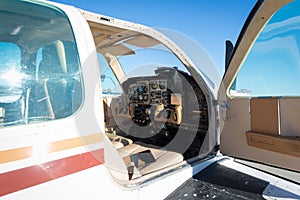 Cockpit of small white propeller aircraft plane