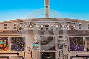cockpit view of a commercial jet airliner with pilot in cruise phase of flight