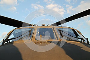 Cockpit windshield of a olive drab military helicopter