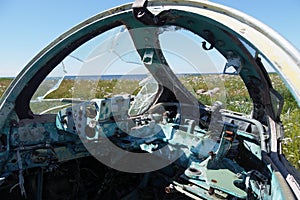 Cockpit of wrecked military aircraft. Blisters are broken
