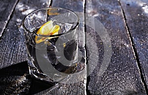 Cocktail with activated charcoal on ice