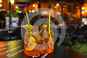 Cocktail alcohol party concept with aperol spritz in jars â€“ romantic night
