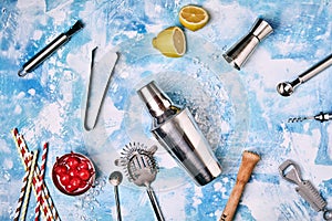 Cocktail Bar utensils scattered on blue background