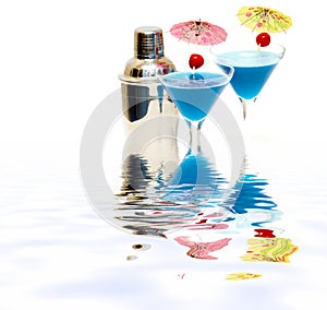 Cocktail with blue curacao & shaker with reflection on water